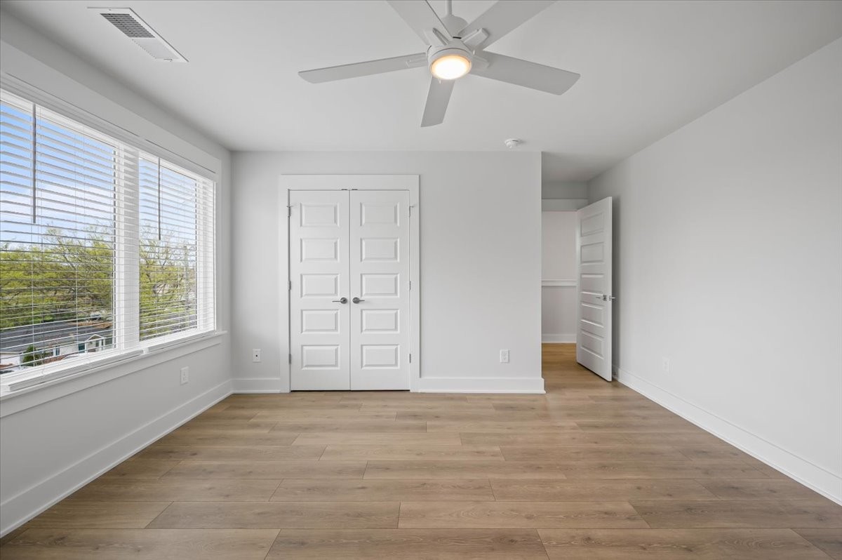 3045 B Hillside Road Nashville, TN 37207 - Photo 23 of 32 an empty room with wooden floor fan and windows
