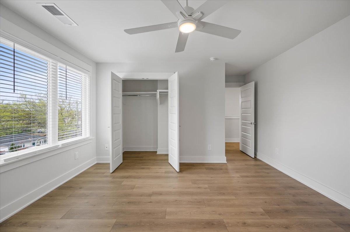 3045 B Hillside Road Nashville, TN 37207 - Photo 24 of 32 an empty room with wooden floor fan and windows