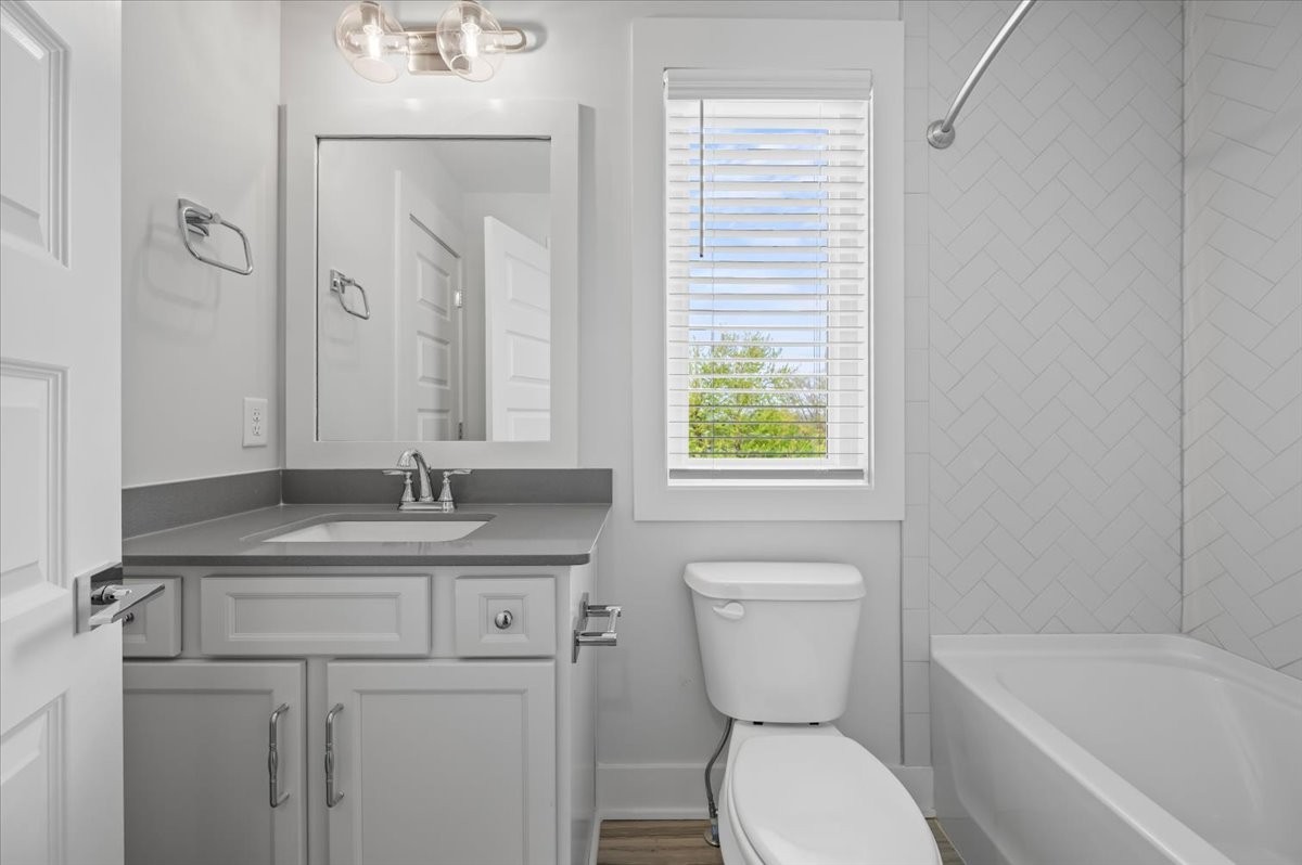 3045 B Hillside Road Nashville, TN 37207 - Photo 25 of 32 a bathroom with a granite countertop toilet a sink and a bathtub