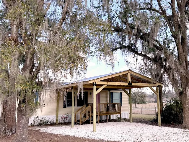 a view of a house with a tree beside it