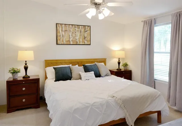 a bedroom with a bed and a chandelier