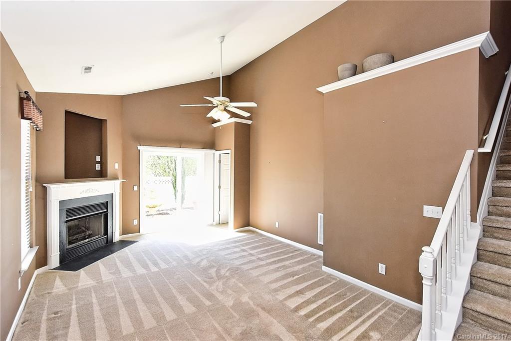 919 Azurine Circle, Unit 69 Fort Mill, SC 29708 - Photo 3 of 22 a bedroom with a bed and a fireplace