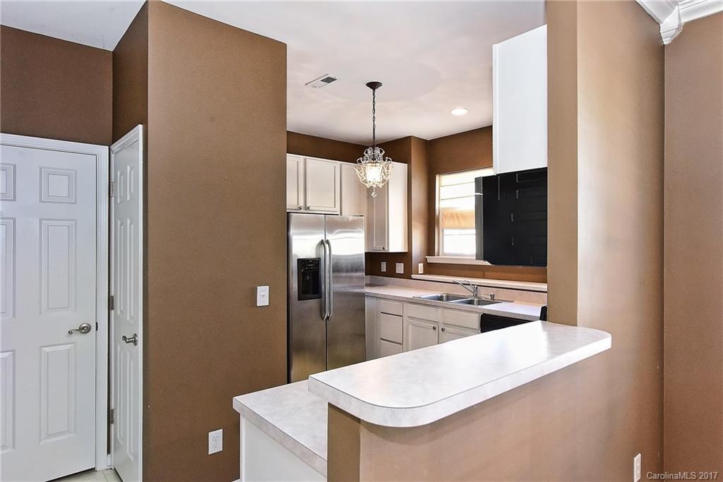 919 Azurine Circle, Unit 69 Fort Mill, SC 29708 - Photo 9 of 22 a kitchen with kitchen island a counter top space a sink stainless steel appliances and cabinets