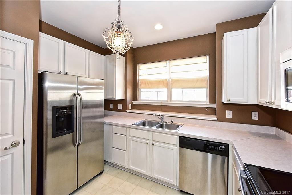 919 Azurine Circle, Unit 69 Fort Mill, SC 29708 - Photo 10 of 22 a kitchen with a refrigerator and a sink