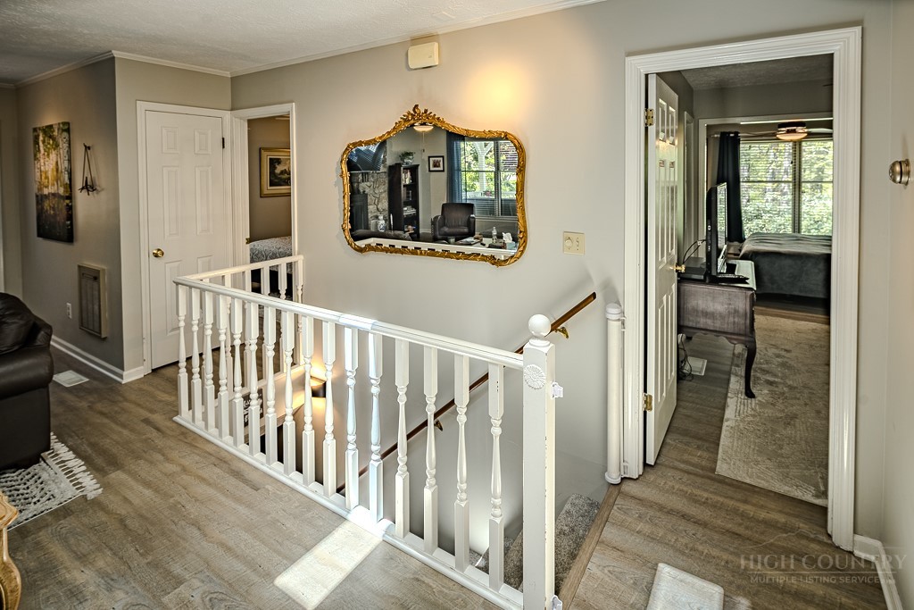 38 Rocky Meadows Road Newland, NC 28657 - Photo 14 of 50 a view of a hallway with wooden floor and stairs
