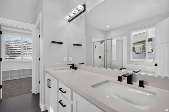 36 West Syracuse Road Vineyard, UT 84059 - Photo 27 of 56 Dual vanity with integrated sinks, light-toned countertops, and matte black hardware