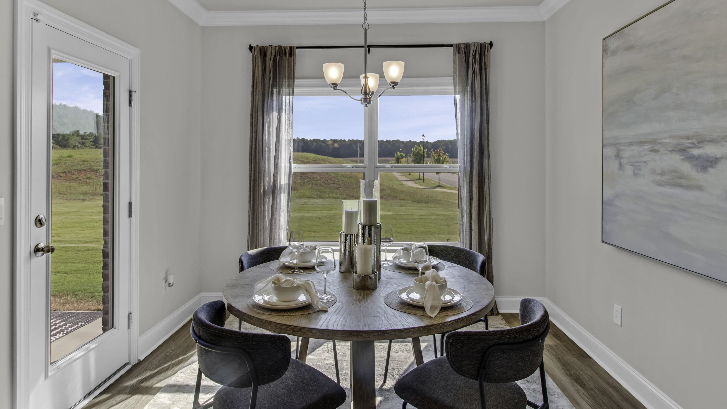 990 Mewborn Farm Road Oakland, TN 38060 - Photo 11 of 40 Dining space featuring wood finished floors, healthy amount of natural light, hanging lights, and ornamental molding