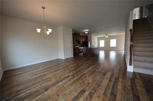 a view of a room with wooden floor