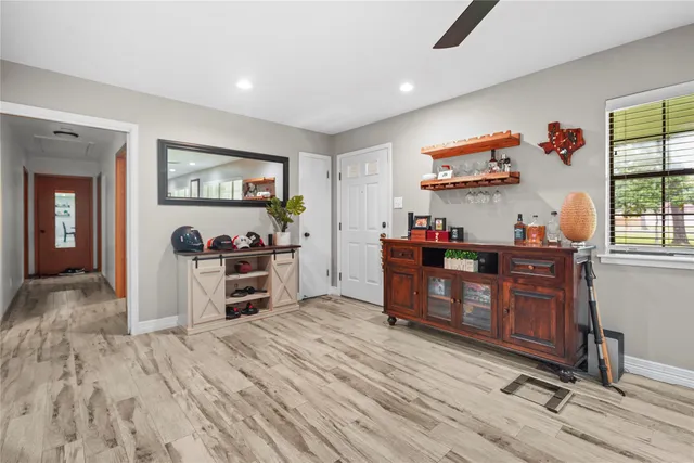 a view of a workspace with furniture and a window