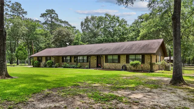 a view of a house with yard and a garden