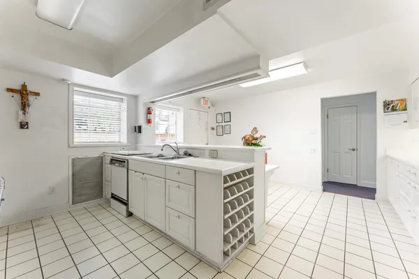 a spacious kitchen with cabinets and window