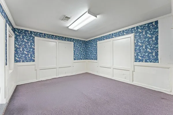 a view of a livingroom with an empty space and window