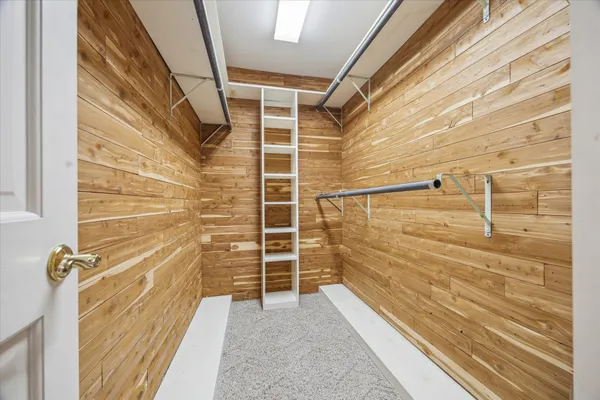 a view of walk in closet with empty racks