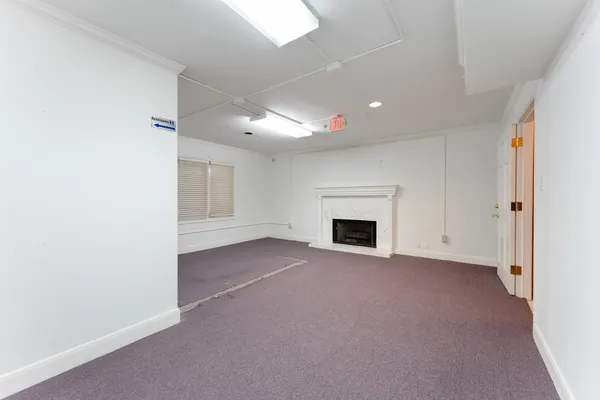 a view of empty room with a fireplace