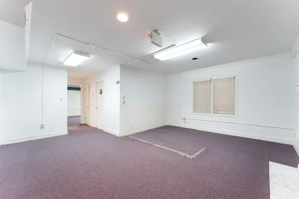 en empty room with windows and closet