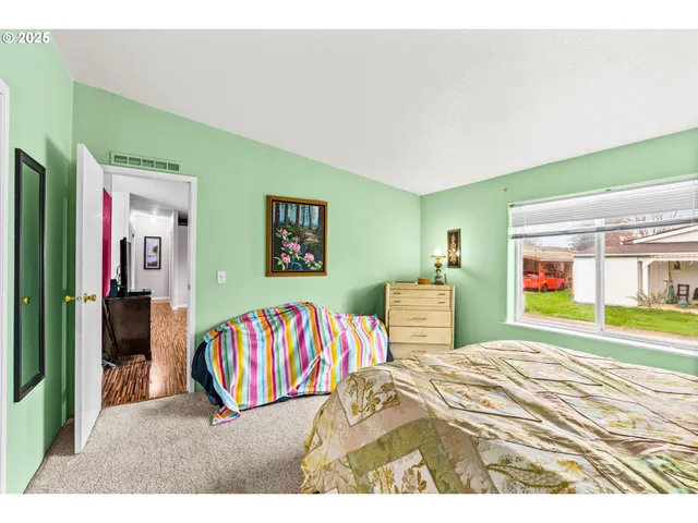 a living room with a bed and a flat screen tv