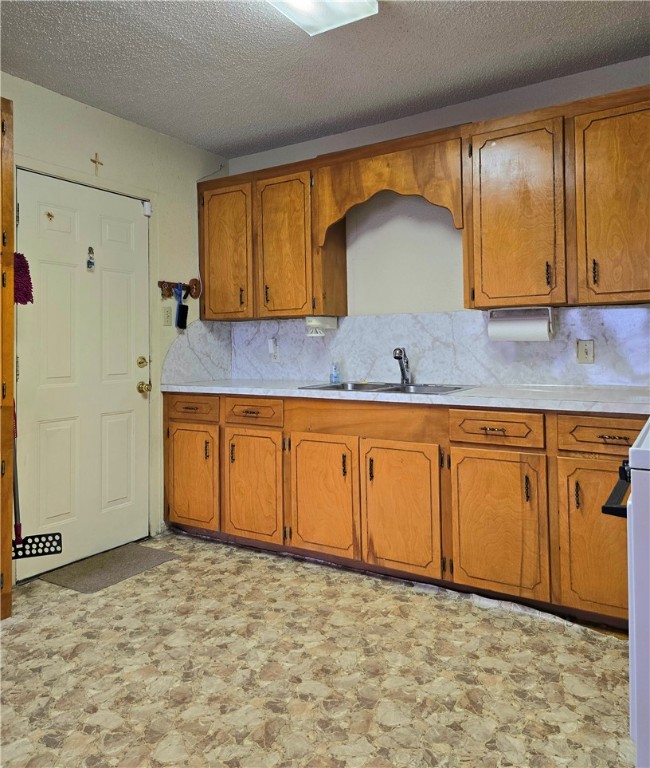 1105 East 5th Street Alice, TX 78332 - Photo 7 of 20 a kitchen with a sink a stove and cabinets