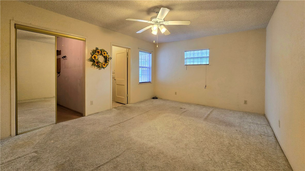 1105 East 5th Street Alice, TX 78332 - Photo 10 of 20 an empty room with windows and ceiling fan
