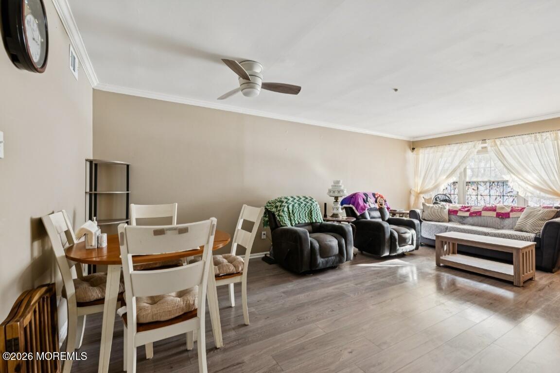 93 Halls Croft Road, Unit C Freehold, NJ 07728 - Photo 16 of 25 a living room with furniture and a chandelier