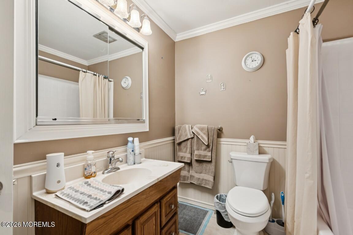 93 Halls Croft Road, Unit C Freehold, NJ 07728 - Photo 8 of 25 a bathroom with a toilet a sink and a mirror