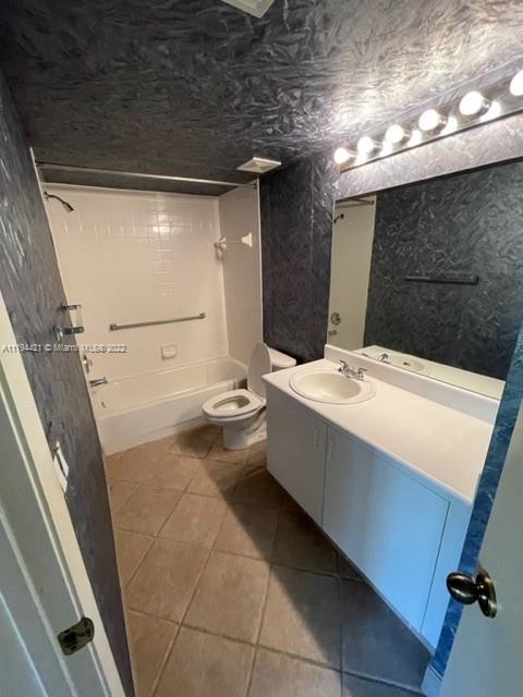 9560 Weldon Circle, Unit J102 Tamarac, FL 33321 - Photo 1 of 7 a bathroom with a sink a toilet and mirror
