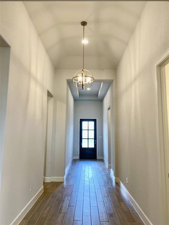 1937 Halkin Road Celina, TX 75009 - Photo 2 of 20 Entryway featuring wood-like tile flooring, a contemporary spherical chandelier, recessed lighting, a tray ceiling detail, and a paneled door with glass inserts