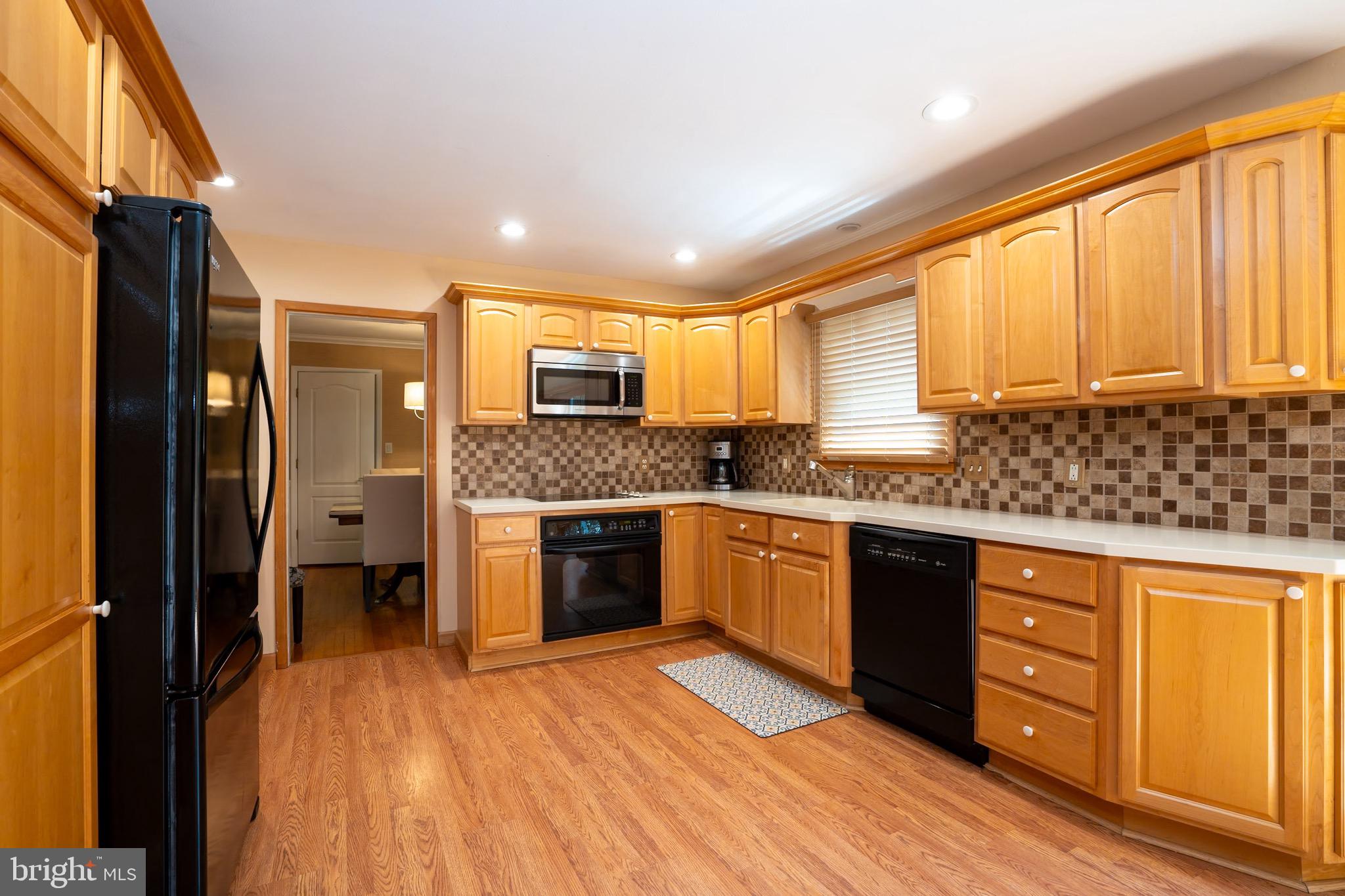 3 Manor Avenue Princeton, NJ 08540 - Photo 12 of 35 a kitchen with stainless steel appliances granite countertop a refrigerator a sink dishwasher a stove and white countertops with wooden floor