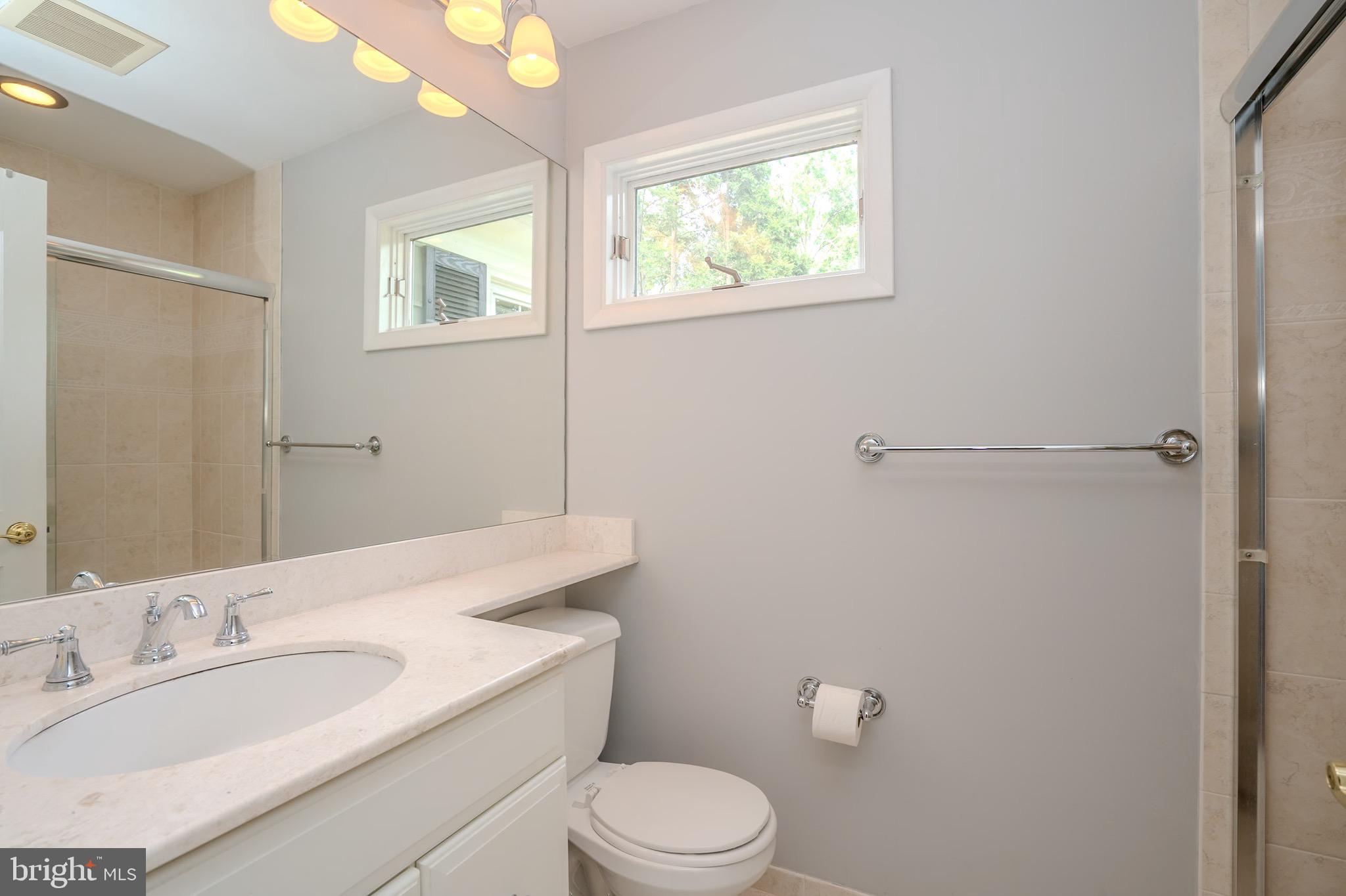 3 Manor Avenue Princeton, NJ 08540 - Photo 23 of 35 a bathroom with a toilet a sink a mirror and a window