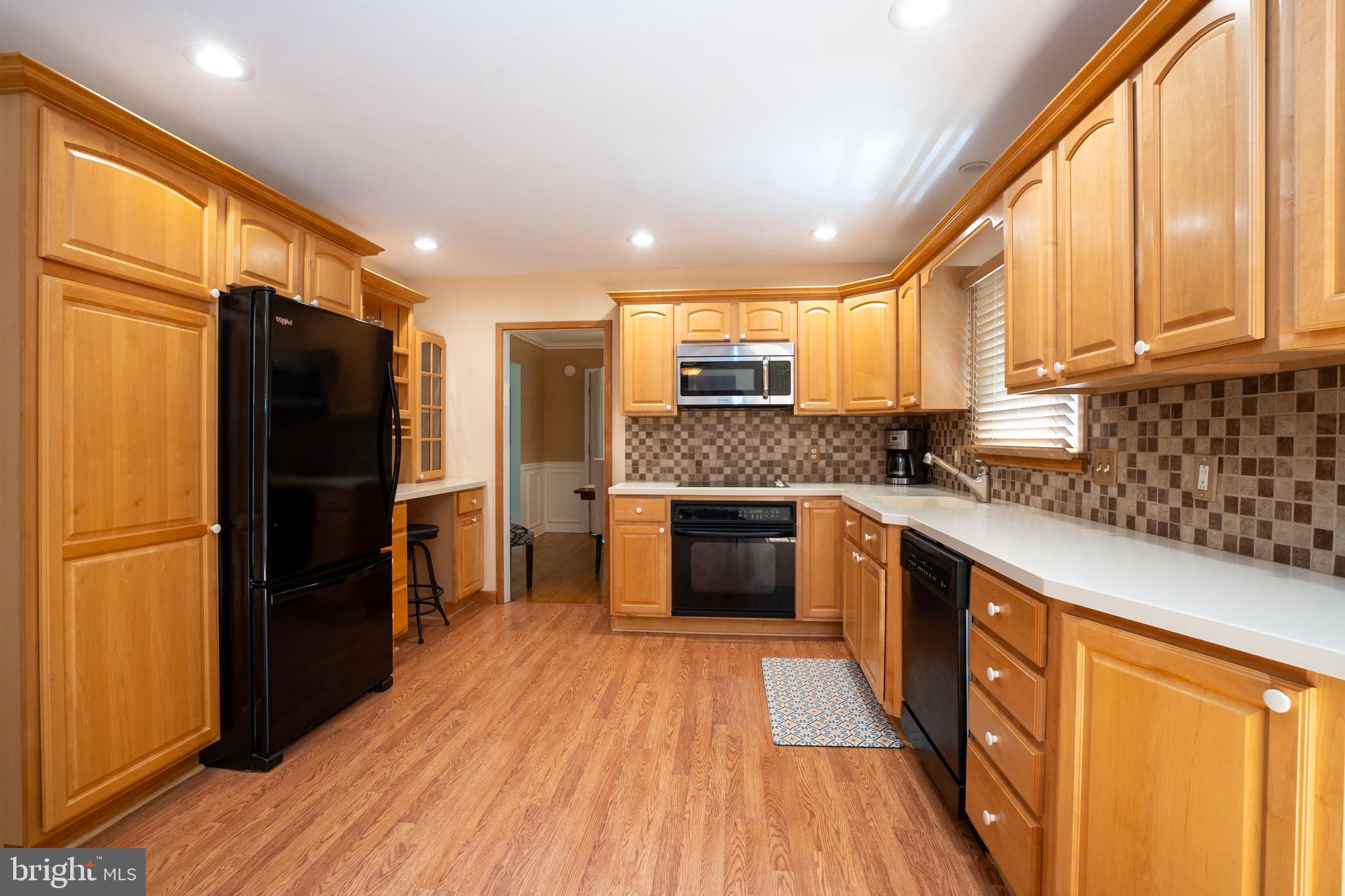3 Manor Avenue Princeton, NJ 08540 - Photo 10 of 35 a kitchen with stainless steel appliances granite countertop a refrigerator a sink dishwasher a stove and white countertops with wooden floor