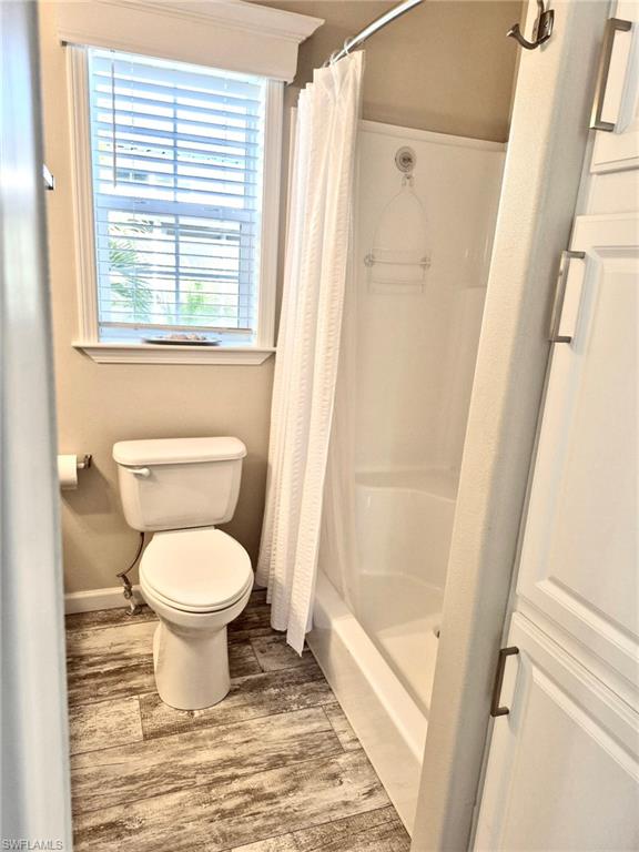 173 Redwood Lane, Unit 8 Naples, FL 34114 - Photo 13 of 19 a bathroom with a toilet and a shower a window