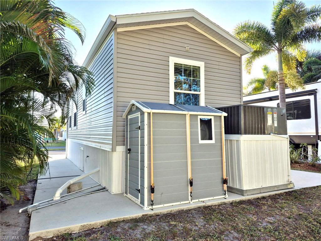 173 Redwood Lane, Unit 8 Naples, FL 34114 - Photo 5 of 19 a front view of a house with a tree
