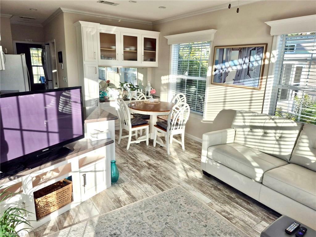 173 Redwood Lane, Unit 8 Naples, FL 34114 - Photo 6 of 19 a living room with furniture and a table
