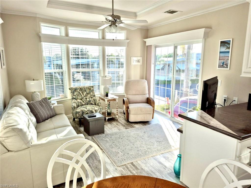 173 Redwood Lane, Unit 8 Naples, FL 34114 - Photo 7 of 19 a living room with furniture and floor to ceiling windows