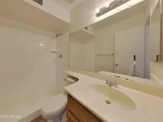 a view of empty room with window and wooden floor