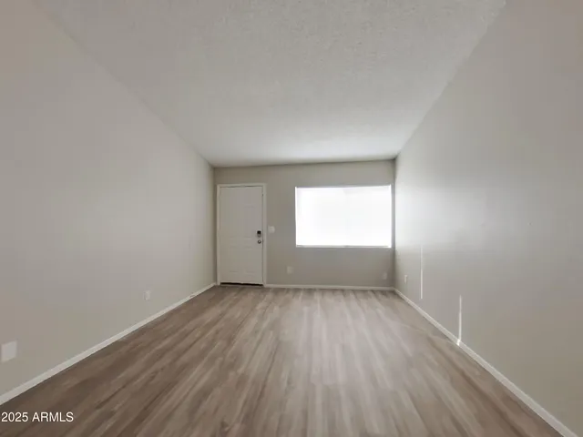 a view of a room with wooden floor