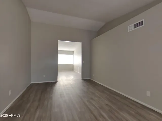 a view of a room with window and wooden floor