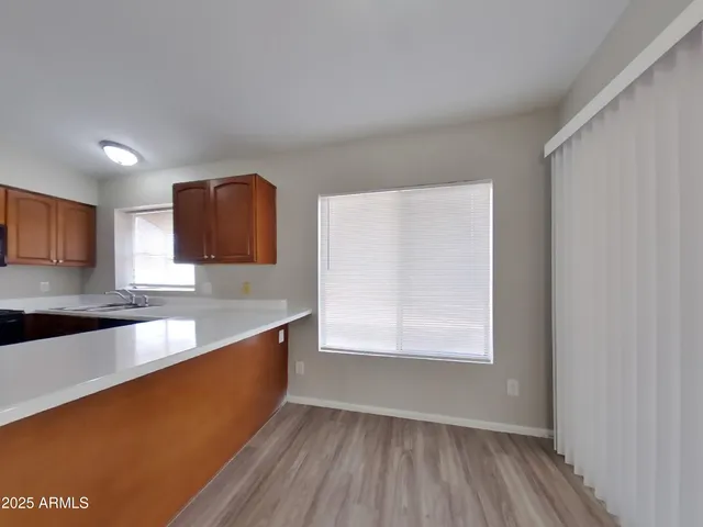 a view of wooden floor and windows in a room