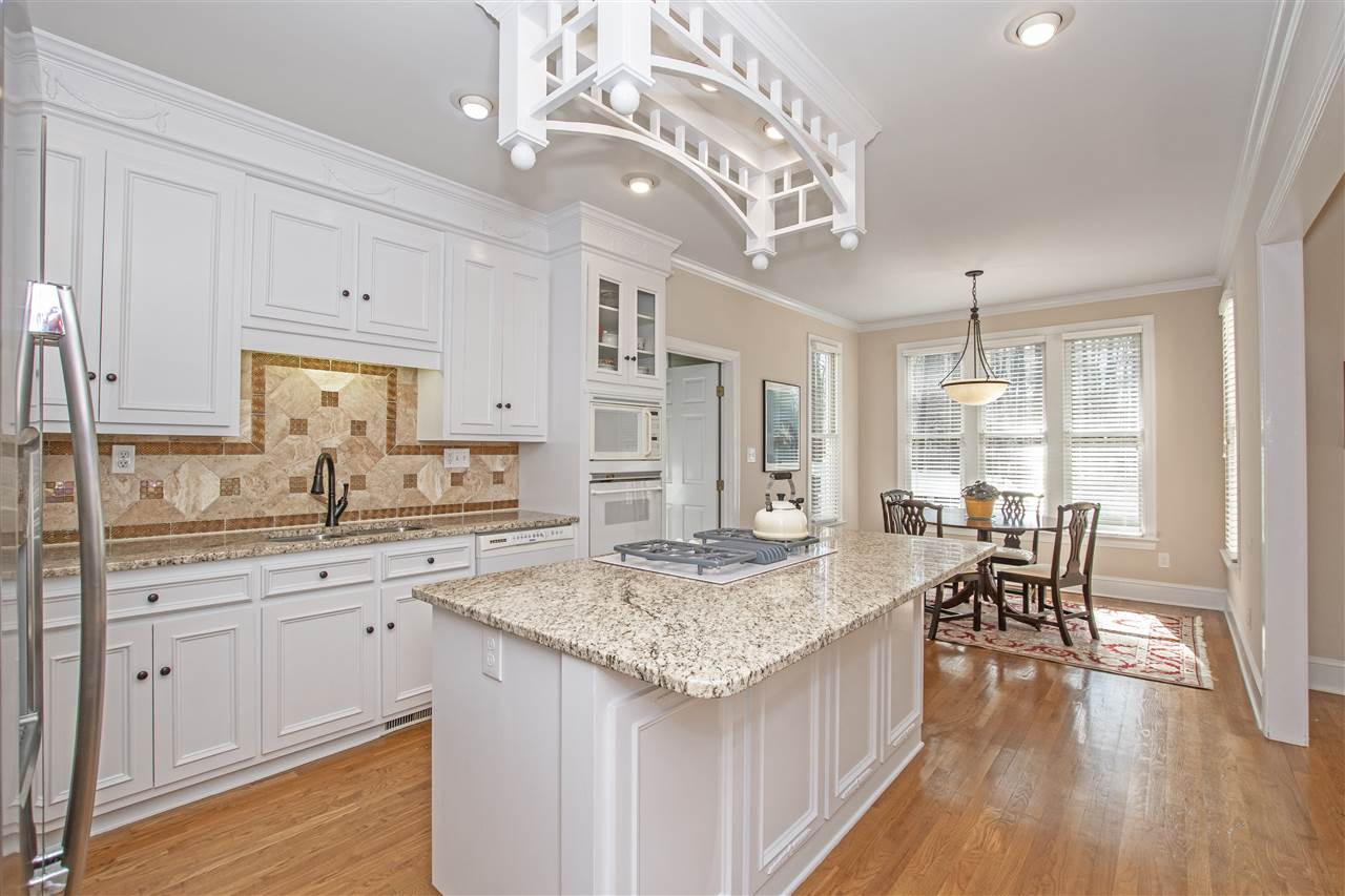 The large kitchen area is open to the great room and breakfast area. Granite counter tops and island, butler's pantry/work station, gas range with downdraft, and lots of cabinet space! Kitchen and Breakfast Area