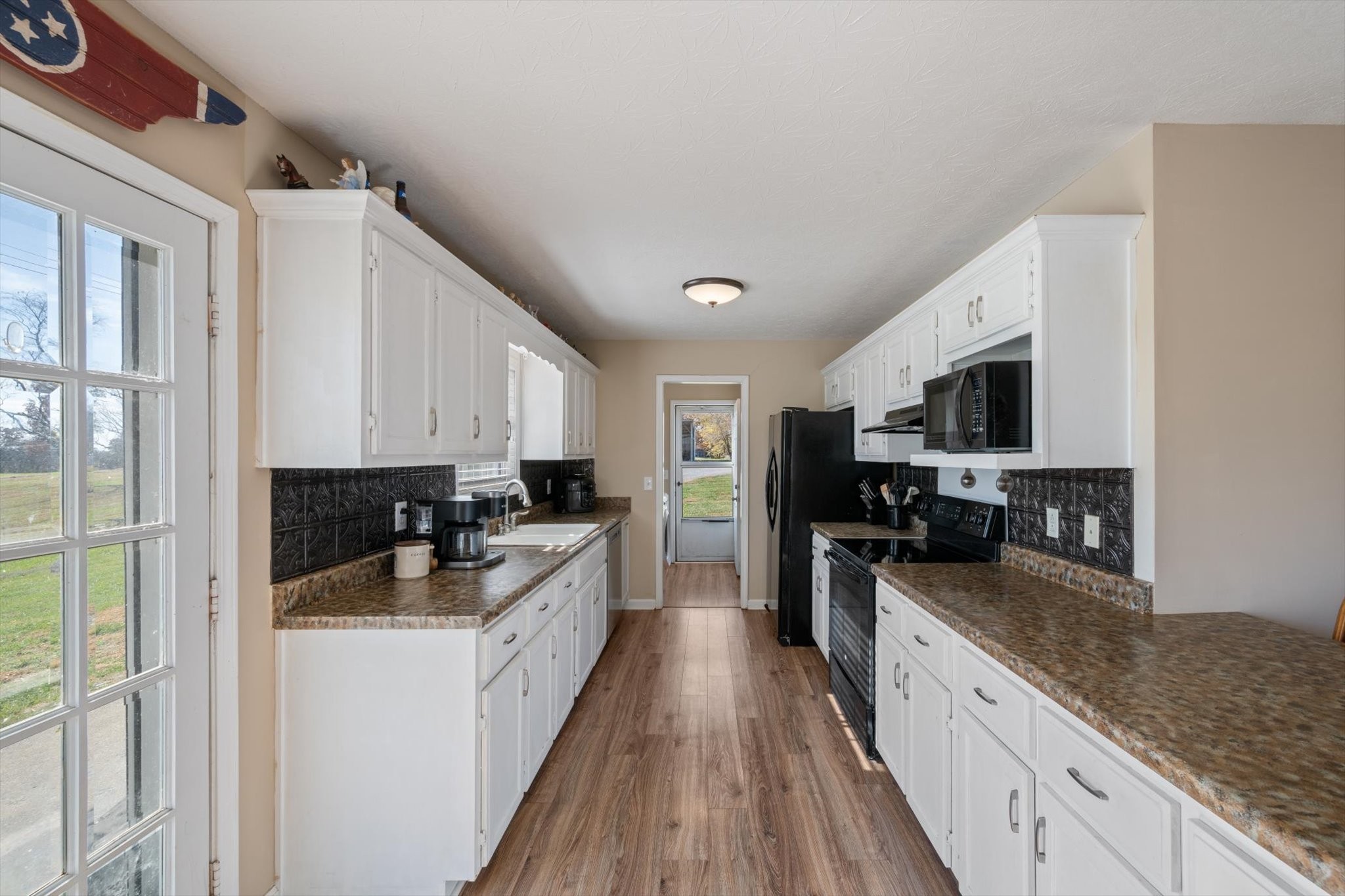 5971 Wayman Dunn Road Springfield, TN 37172 - Photo 11 of 31 a kitchen with a sink a counter top space stainless steel appliances and cabinets