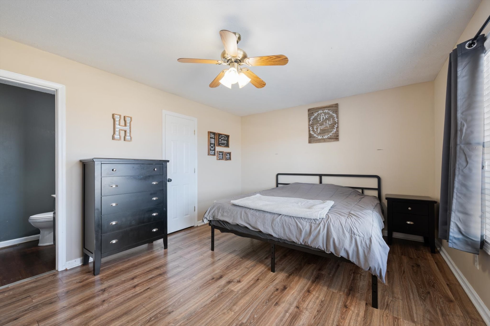 5971 Wayman Dunn Road Springfield, TN 37172 - Photo 14 of 31 a bedroom with a bed and a chandelier