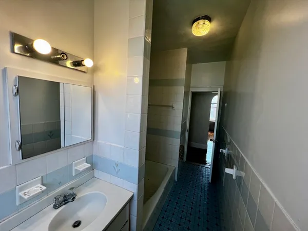 a bathroom with a sink and mirror