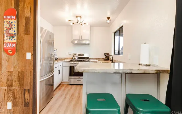 a bedroom with a bed and a lamp next to a large window