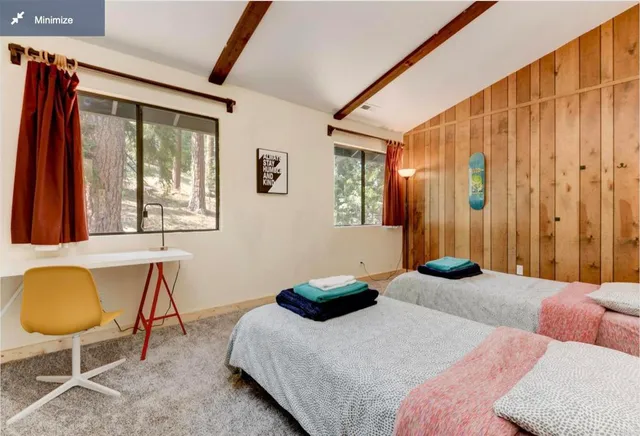 a bedroom with bed and glass windows