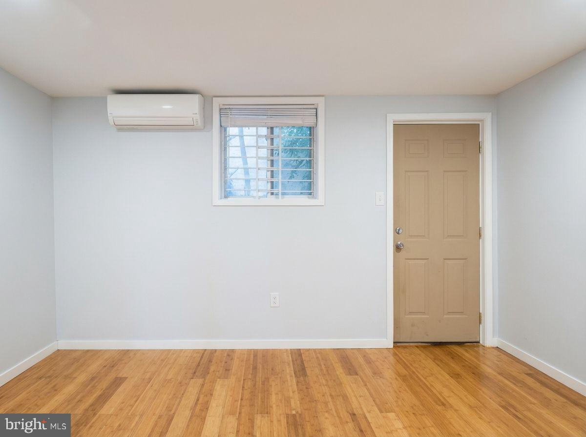 1525 West Seybert Street, Unit A Philadelphia, PA 19121 - Photo 2 of 6 an empty room with wooden floor and windows