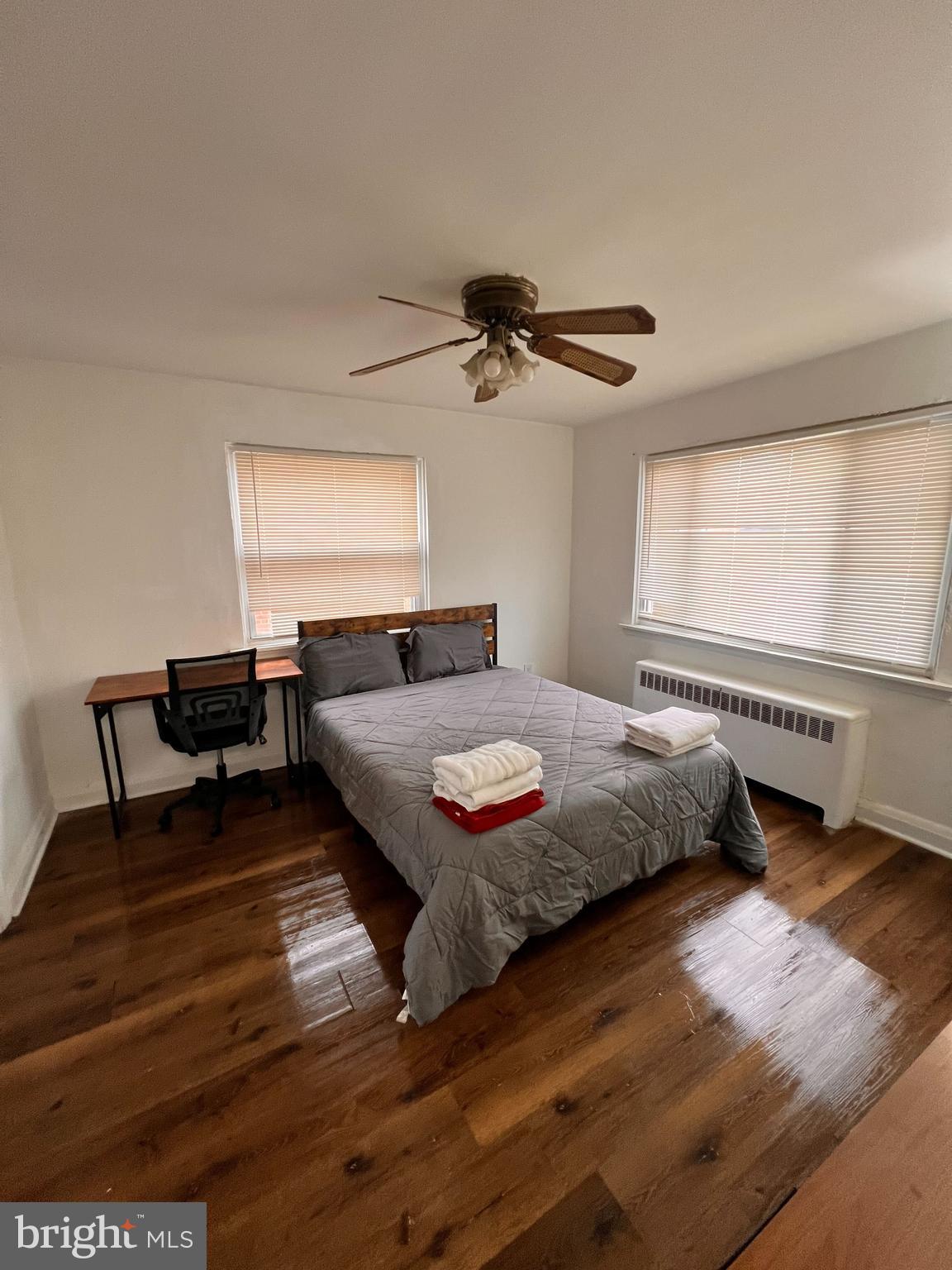 8529 Chestnut Oak Road Parkville, MD 21234 - Photo 12 of 23 a bedroom with a bed and a chandelier
