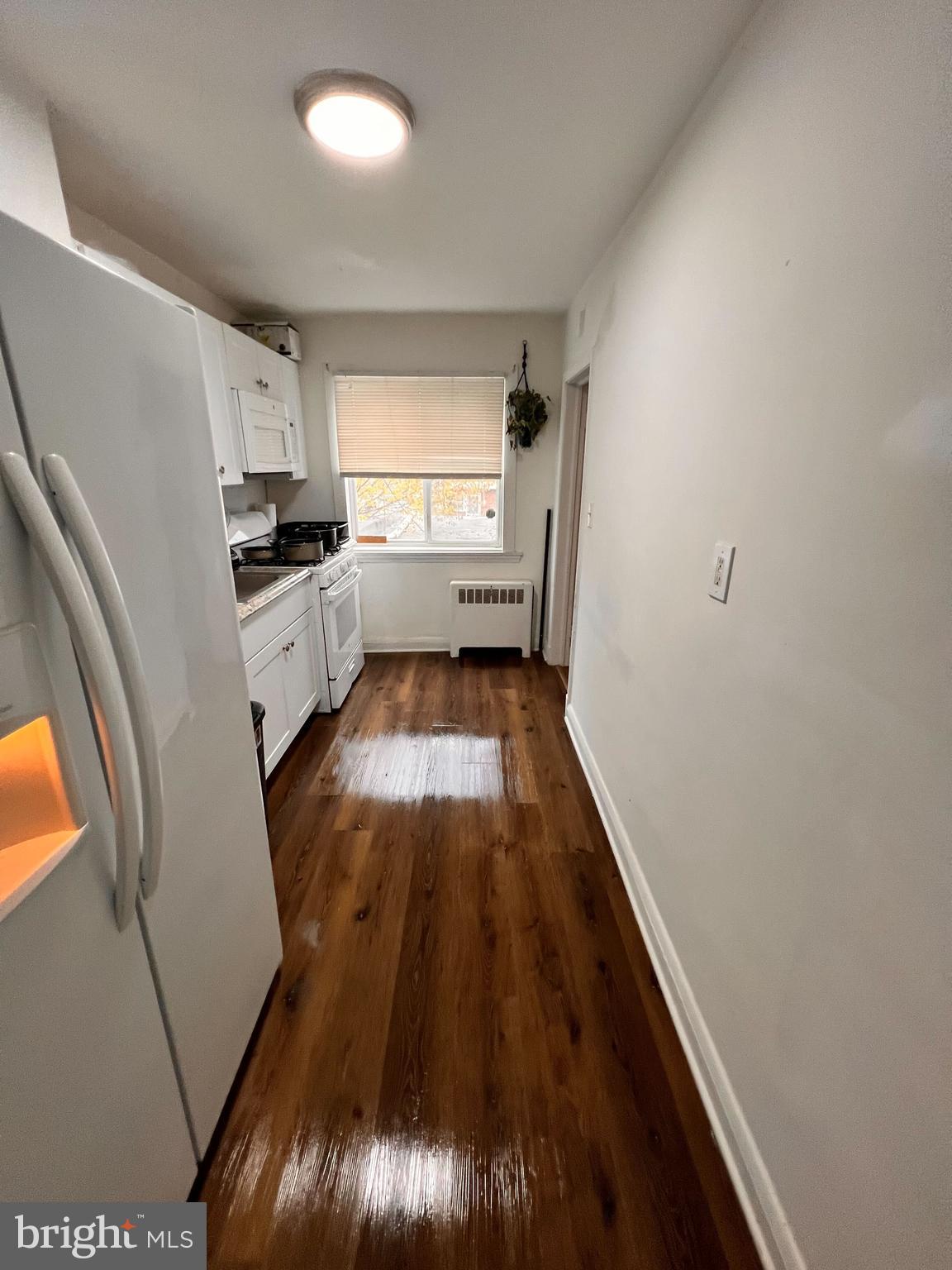 8529 Chestnut Oak Road Parkville, MD 21234 - Photo 19 of 23 a kitchen with sink a refrigerator and window
