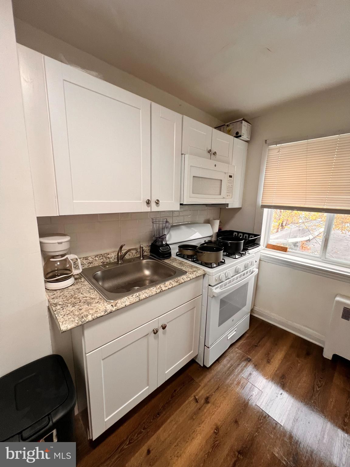 8529 Chestnut Oak Road Parkville, MD 21234 - Photo 20 of 23 a kitchen with granite countertop white cabinets and white appliances