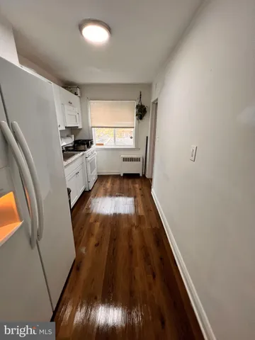 a kitchen with sink a refrigerator and window