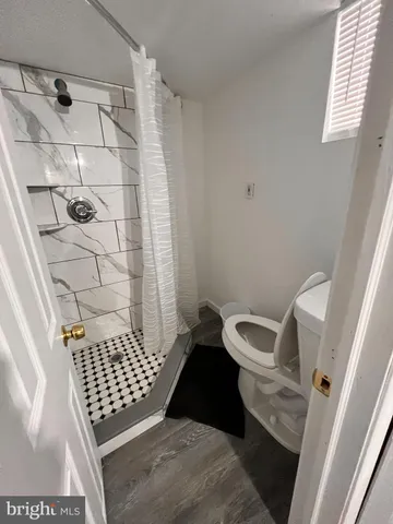 a bathroom with a toilet and shower