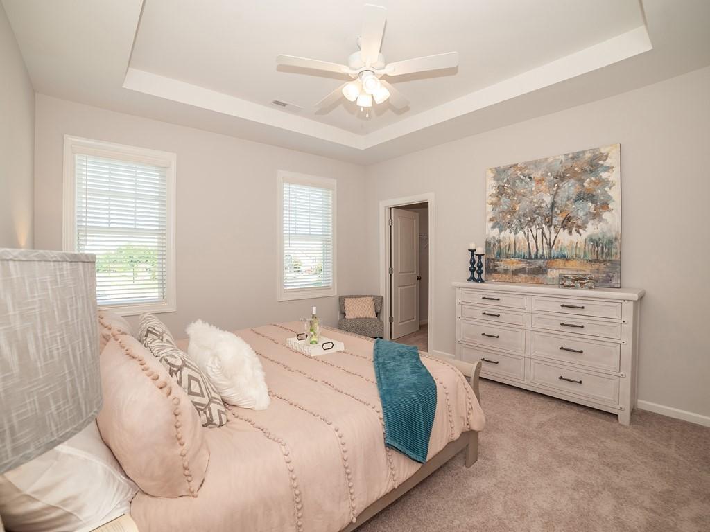 154 Rolesville Ridge Drive Rolesville, NC 27571 - Photo 5 of 9 a bedroom with a bed and a dresser